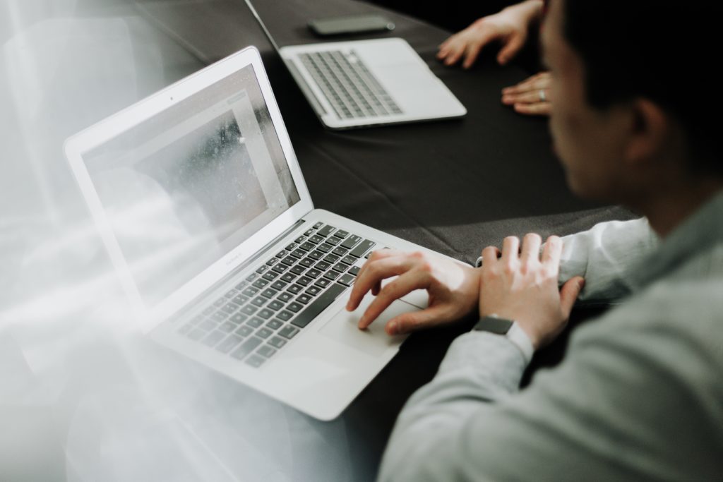 person typing on a laptop computer