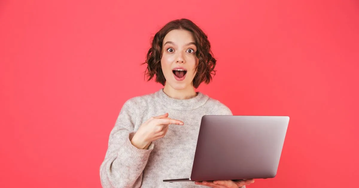 A woman holding her laptop expresses excitement at how technology can improve digital clutter.