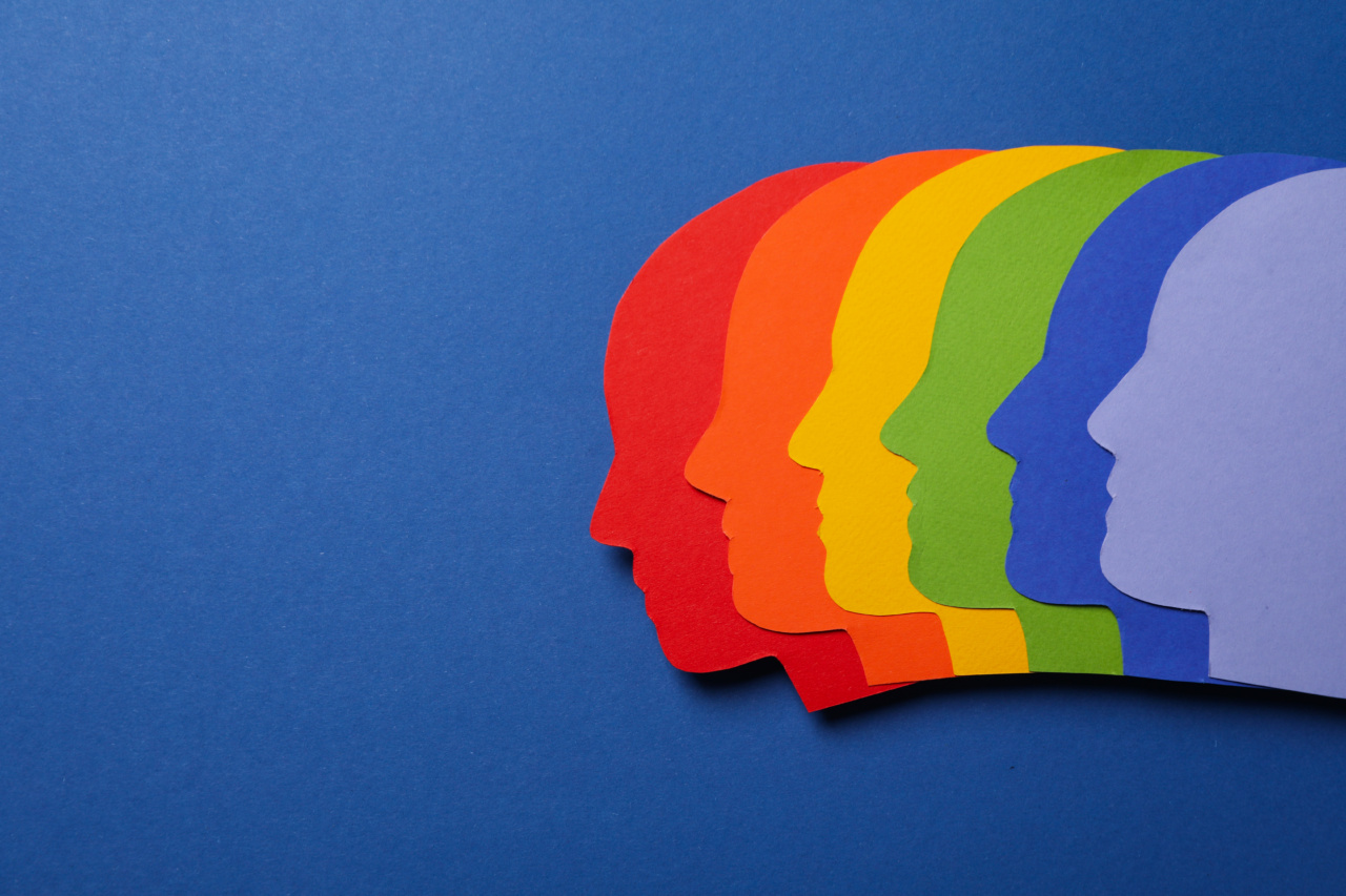 A collection of paper faces in the colors of the Pride flag, representing what is DEI