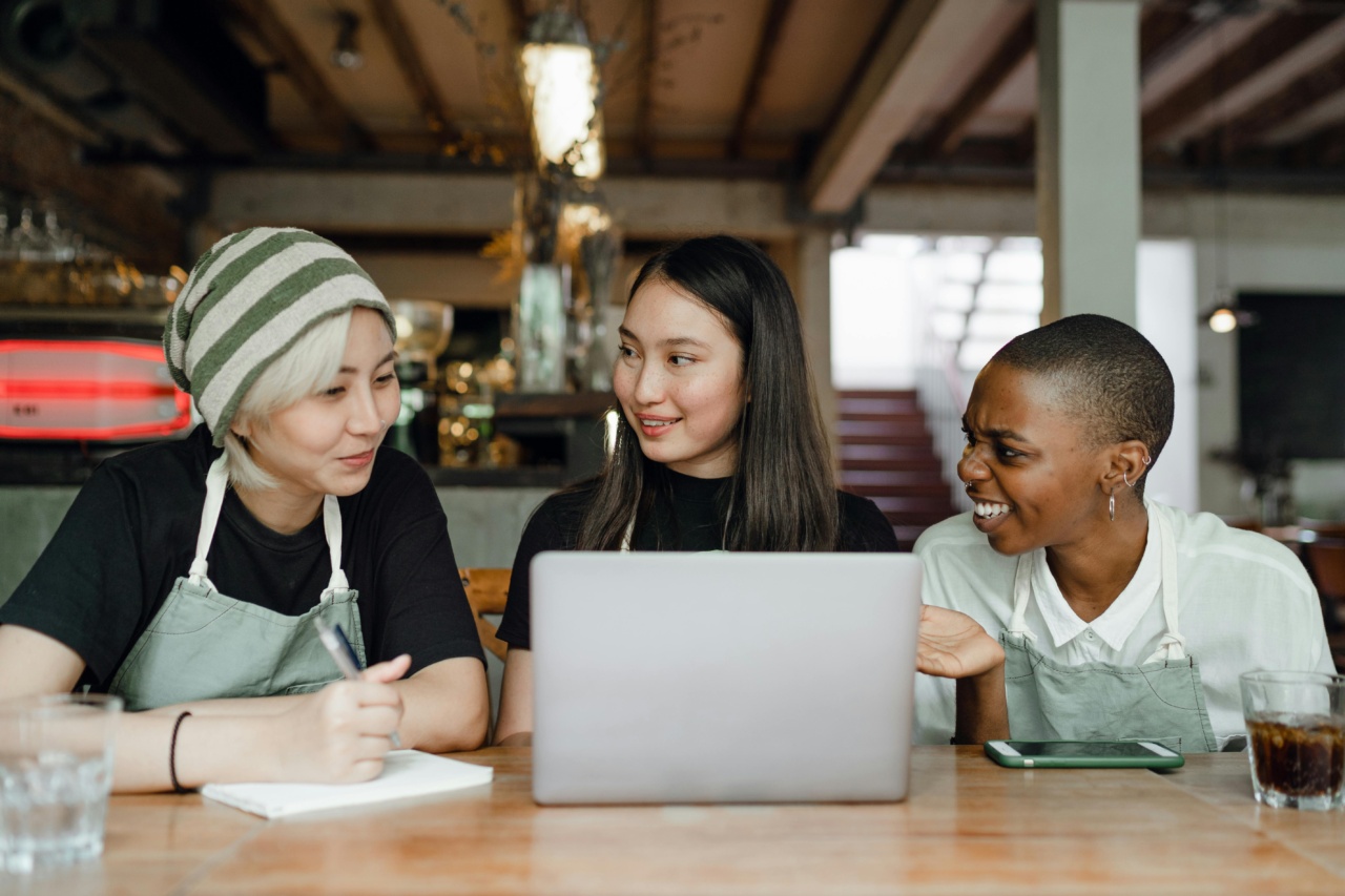 Happy waitresses using laptop, representing connected frontline workers