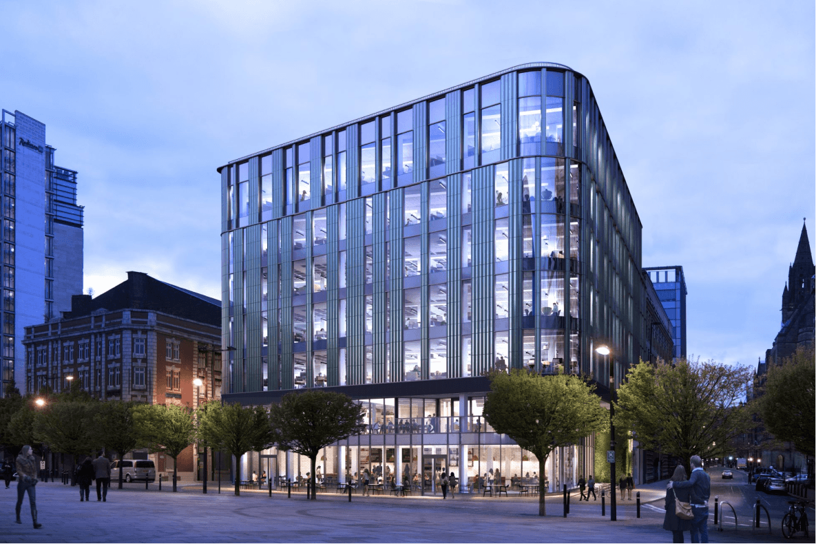 Windmill Green building where Interact is headquartered, illuminated at dusk and surrounded by trees and pedestrians in an urban city center.