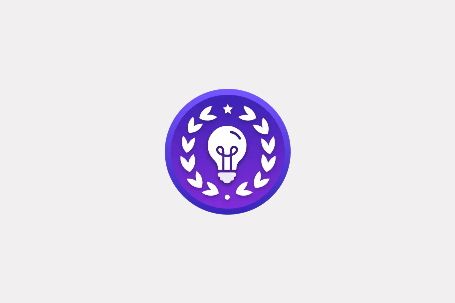 A purple circular achievement badge featuring a lightbulb framed by a laurel wreath and star.